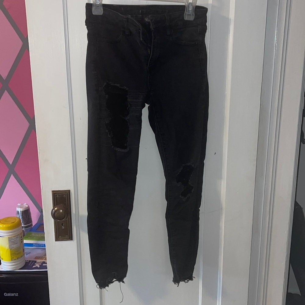 Black ripped jeans. Very worn